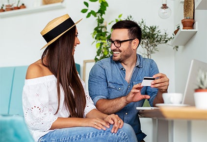 man and woman sharing gift card